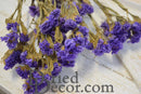 Bulk dried natural lavender statice sinuata flower bunches with brown stems.
