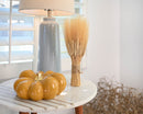 Grande size dried natural wheat stack tied with twine on white table, wholesale bulk decor.