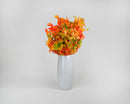 Bundle of dried natural oak leaves in vibrant harvest tones arranged in a white vase for wholesale bulk use.