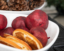 Bulk dried natural pomegranates with dried orange slices in a white bowl for wholesale use.