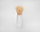 Dried natural blond wheat bunch in a white ceramic vase, decorative wholesale bulk bundle.