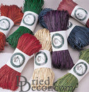 Bundles of dried natural raffia in red, chartreuse, purple, navy, green, and natural colors, wholesale bulk supplies.